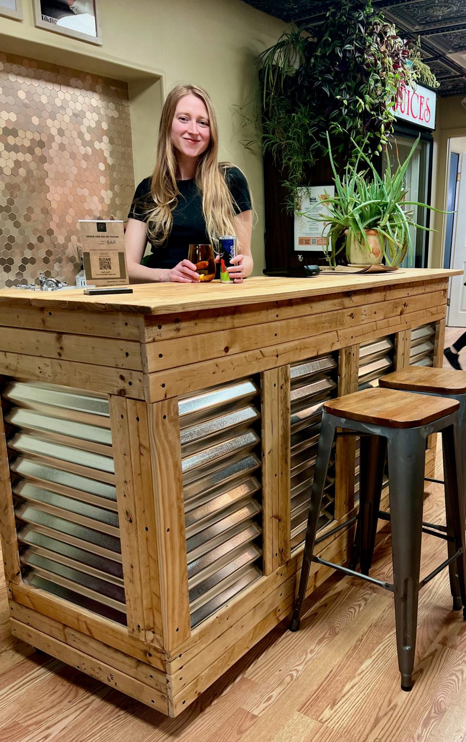 Madeleine Schweitzer, Flour Girl and Flame’s general manager, at the storefront dining room's petite bar. The pizzeria has canned wine and beer, as well as a few wines by the bottle, as well as Wisconsin-made shrubs, kombucha and soda.