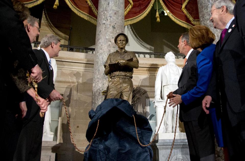 From left, House Minority Leader Nancy Pelosi of Calif., Senate Minority Leader Mitch McConnell of Ky., Agriculture Secretary Tom Vilsack, House Speaker John Boehner of Ohio, Jeanie Borlaug Laube, daughter of Dr. Norman E. Borlaug, and Iowa Gov. Terry Branstad, look to a statue of the late Dr. Norman E. Borlaug during its unveiling in National Statuary Hall on Capitol Hill in Washington, Tuesday, March 25, 2014. (AP Photo/Carolyn Kaster)