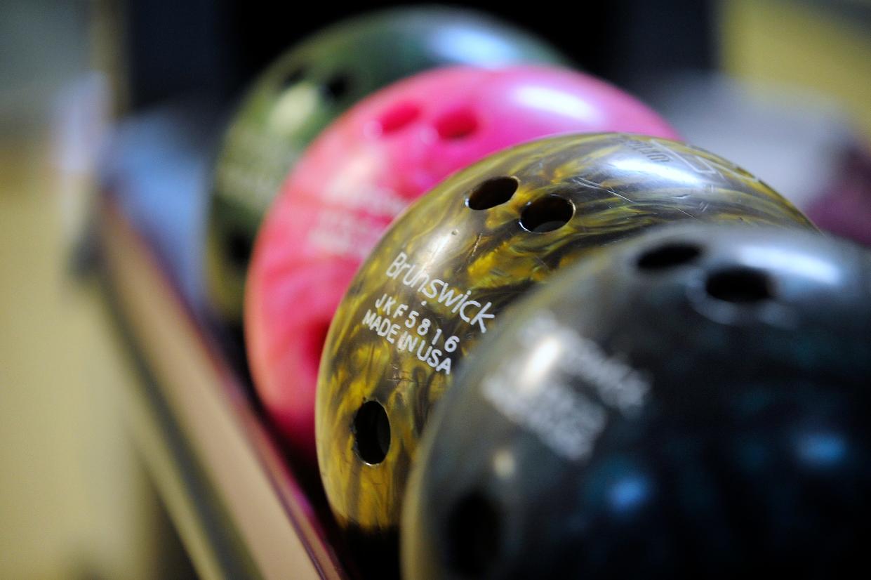 FILE - Bowling balls sit ready for throwing.