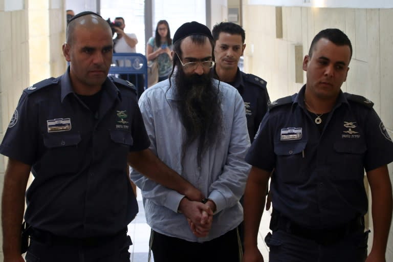 Ultra-Orthodox Jew Yishai Shlissel (C), convicted of killing a 16-year-old Israeli girl during the 2015 Jerusalem Gay Pride parade, is escorted into court in Jerusalem on June 26, 2016