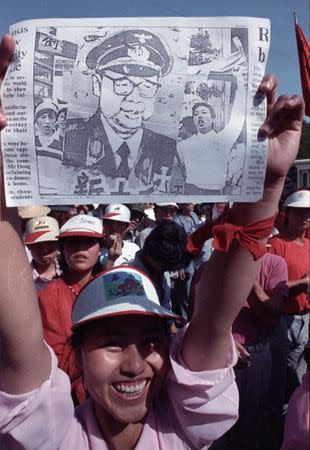 FILE PHOTO: A Chinese protester holds up a caricature of Premier Li Peng dressed in a Nazi uniform during an anti-government demonstration in Tiananmen Square in Beijing, China, May 25, 1989. REUTERS/Ed Nachtrieb/Files