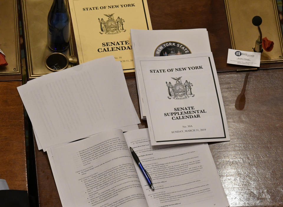 View of desk top as Senate members debate budget bills in the Senate Chamber at the state Capitol Sunday, March, 31, 2019, in Albany, N.Y. (AP Photo/Hans Pennink)