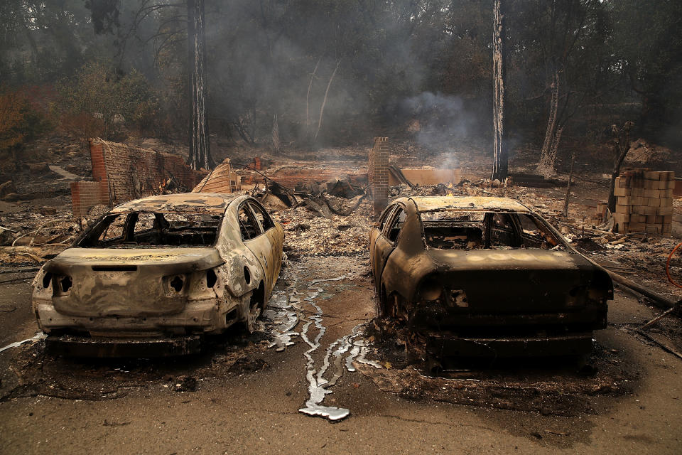 <p>GLBurned cars sit idle after an out of control wildfire moved through the area on October 9, 2017 in Glen Ellen, Calif. (Photo: Justin Sullivan/Getty Images) </p>