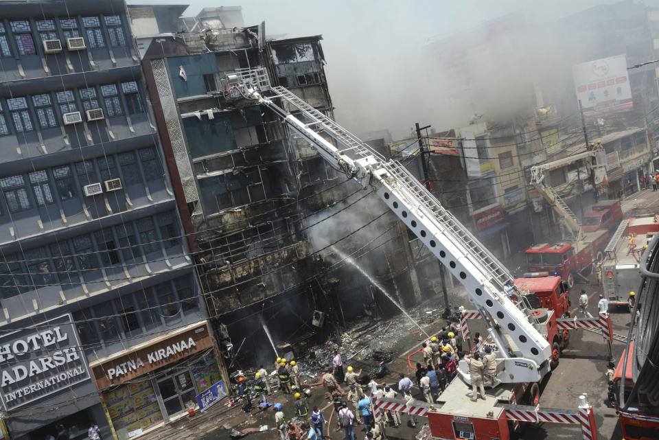 Firefighters douse a fire which broke out in a restaurant and hotel near the Patna Junction railway station, in Patna, Bihar, India, Thursday, April 25, 2024. (AP Photo/Aftab Alam Siddiqui)