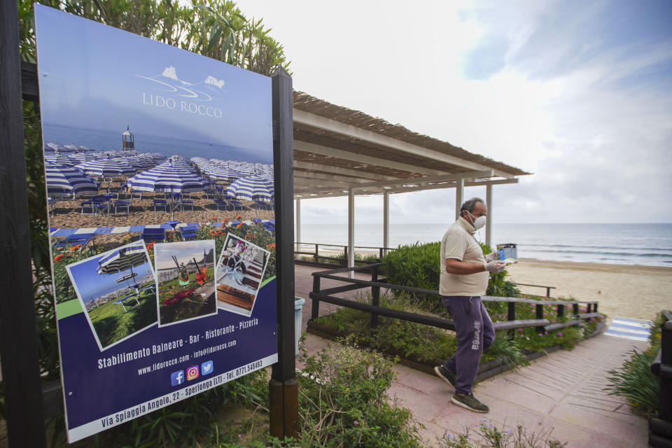 In this picture taken on Tuesday, April 28, 2020, resort owner Lucio Daniele Faiola walks on the grounds of his resort, in Sperlonga, a fashionable seaside town about 120km (80 miles) south of Rome. Though Italy is gradually reopening from a two-month lockdown, there is no word on when and how beach establishments can open for visitors. (AP Photo/Andrew Medichini)