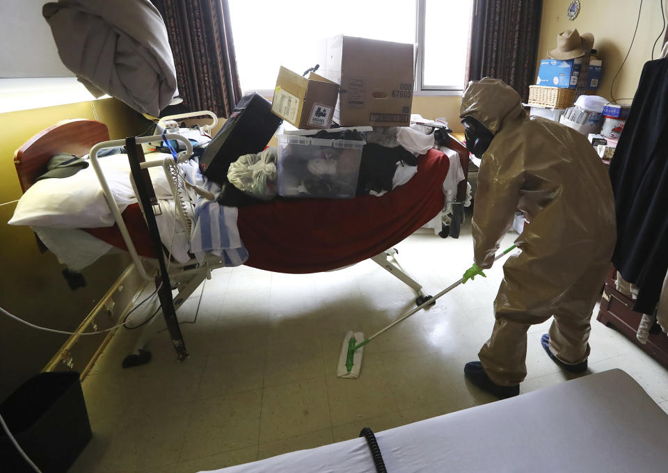 A member of Georgia's National Guard cleans and sanitizes a nursing home room. Some states are using troops to help with infection control and staff shortages. (Photo: ASSOCIATED PRESS)