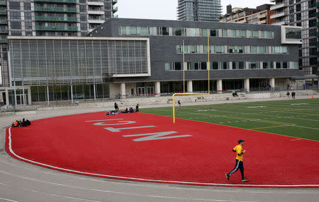 Students congregate on the playing field of the North Toronto Collegiate Institute, a high school run by the Toronto District School Board in Toronto, Ontario, Canada March 24, 2017. REUTERS/Chris Helgren