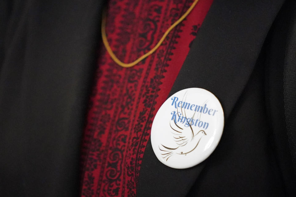 A woman wears a button reading "Remember Kingston" as she attends a Tennessee Supreme Court hearing Wednesday, June 1, 2022, in Nashville, Tenn. The court heard arguments that can determine whether workers at Tennessee Valley Authority's Kingston Fossil Plant have legal recourse to sue for damages they say were caused by their exposure to coal ash after a 2008 spill at the plant. (AP Photo/Mark Humphrey)