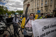 Delivery workers protest in front of the Spanish Parliament in Madrid, Spain, Tuesday, May 11, 2021. Spain has approved a pioneering law that gives delivery platforms a mid-August deadline to hire the workers currently freelancing for them and that requires transparency of artificial intelligence to manage workforces. (AP Photo/Manu Fernandez)