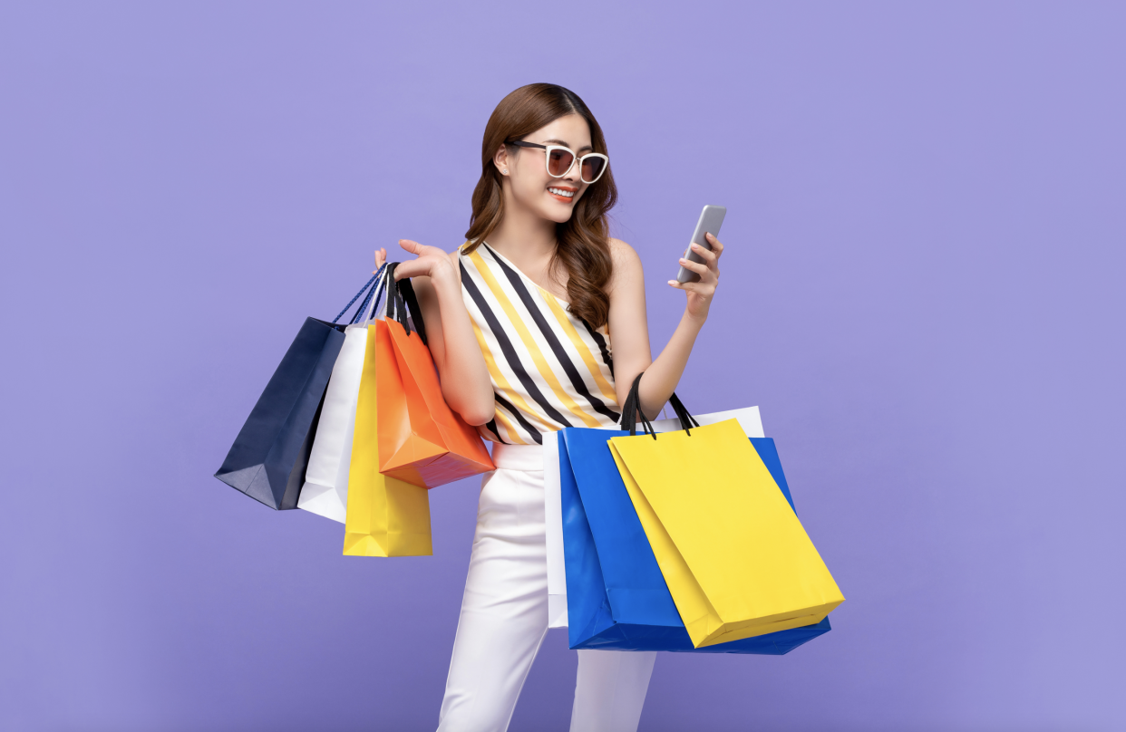 Person holding colorful shopping bags