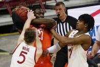 Illinois's Kofi Cockburn gets tied up by Wisconsin's Tyler Wahl and Aleem Ford during the second half of an NCAA college basketball game Saturday, Feb. 27, 2021, in Madison, Wis. (AP Photo/Morry Gash)