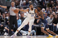 Dallas Mavericks guard Spencer Dinwiddie, left, is defended by Denver Nuggets guard Bones Hyland during the second half of an NBA basketball game Tuesday, Dec. 6, 2022, in Denver. (AP Photo/David Zalubowski)