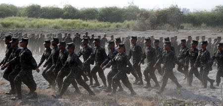 Members of the Philippine Navy march as they arrive on the shore of San Antonio, Zambales to watch the annual "Balikatan" (shoulder-to-shoulder) war games between the U.S. and Filipino soldiers in northern Philippines April 21, 2015. REUTERS/Erik De Castro