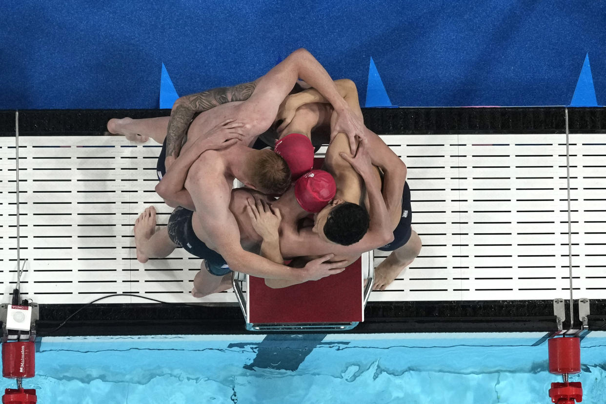 Team Britain celebrate after winning the men's 4 x 200-meter freestyle relay at the 2024 Summer Olympics on July 30, 2024, in Nanterre, France. (David J. Phillip/AP)