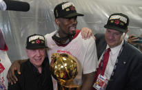 Toronto Raptors center Serge Ibaka, middle, celebrates with Larry Tanenbaum, left, and George Cope after the Raptors defeated the Golden State Warriors in Game 6 of basketball's NBA Finals in Oakland, Calif., Thursday, June 13, 2019. (AP Photo/Tony Avelar)