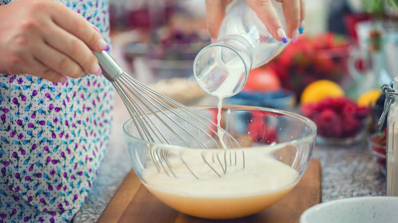 pouring milk into batter