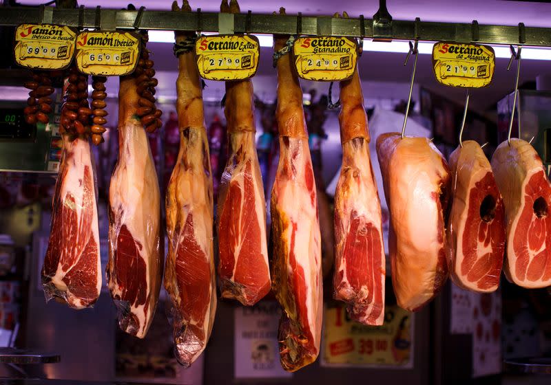 FILE PHOTO: Spanish Iberico and Serrano hams are seen hanging at the Anton Martin market in Madrid