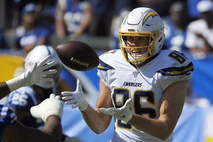 FILE- In this Sunday, Sept. 8, 2019, file photo, Los Angeles Chargers tight end Hunter Henry, right, makes a catch during the second half of an NFL football game against the Indianapolis Colts in Carson, Calif. Henry will be placed on injured reserve because of a knee injury. He fractured the upper part of his left tibia during Sunday's 30-24 overtime win over the Colts. (AP Photo/Mark J. Terrill, File)
