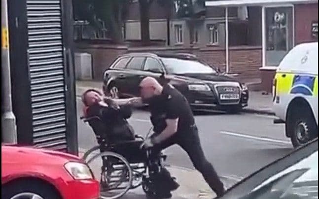 A screenshot from the social media video showing a Norfolk police officer allegedly hitting and punching a one-legged disabled man