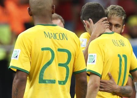 Brazil's Neymar (R) consoles teammate Oscar after their loss to the Netherlands in their 2014 World Cup third-place playoff at the Brasilia national stadium in Brasilia July 12, 2014. REUTERS/Ueslei Marcelino