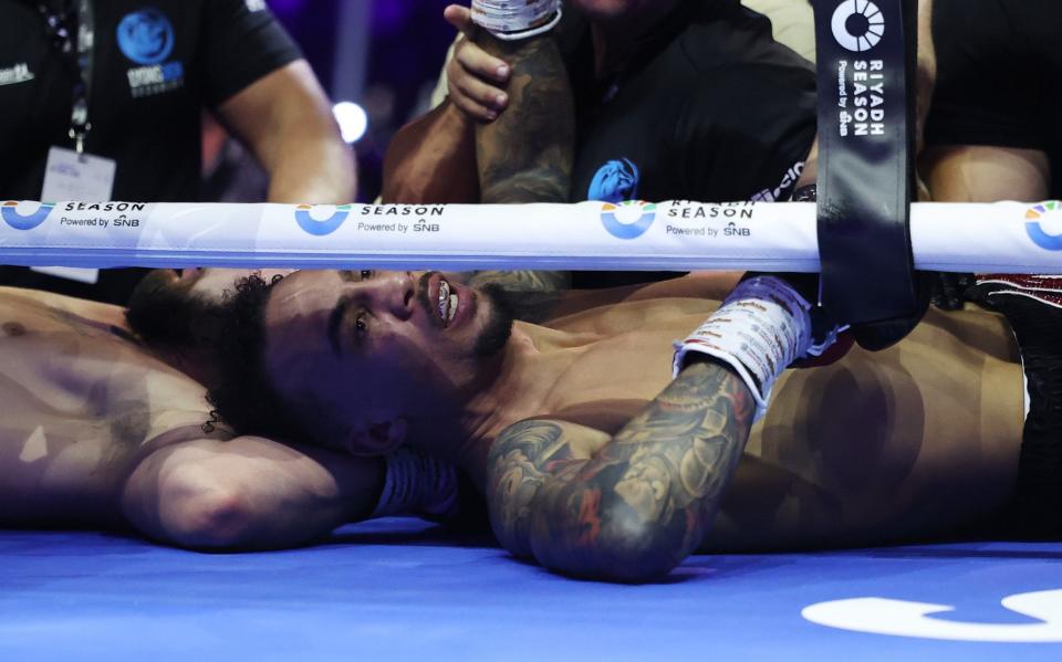 Ben Whittaker reacts after falling out of the ring with Liam Cameron during a clinch during the Light Heavyweight