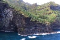 CORRECTS TO DELETE THE REFERENCE OF THE DATE OF THE PHOTO TAKEN AS THE CREATION DATE IS UNKNOWN - This undated photo provided by the Hawaii Department of Land and Natural Resources shows an area over Na Pali Coast State Wilderness Park. There were no survivors of Thursday's Hawaii tour helicopter crash that killed a few minors and several adults, officials confirmed Saturday, Dec. 28, 2019. (Dan Dennison/Hawaii DLNR via AP)