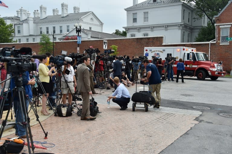 Members of the media gather outside the Navy Yard after a lock down for an unconfirmed shooting at the Navy Yard in Washington, DC on July 2, 2015. The Navy Yard in Washington was put on lockdown Thursday amid unconfirmed reports of an active gunman on the military facility, the scene of a deadly shooting two years ago, the US Navy said. A Navy officer who was inside the complex told CNN people scrambled for cover after hearing someone shout to get out of the building and stay away from the cafeteria. But Lieutenant Commander Scott Williams said he heard no shots or saw any signs of a struggle. "We heard someone scream, get out of the building, stay away from the cafeteria and we saw everyone running for the exits or adjoining offices," he said. AFP PHOTO/ MLADEN ANTONOV