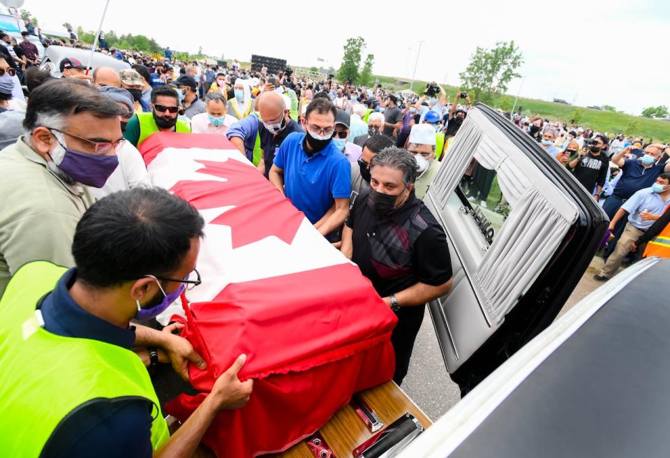 Pallbearers load a casket into a hearse after a funeral service for the four Muslim family members killed in a deadly vehicle attack, at the Islamic Centre of Southwest Ontario in London, Ont., on Saturday, June 12, 2021. Talat Afzaal, 74, her son Salman Afzaal, 46, his wife Madiha Salman, 44, and their 15-year-old daughter Yumna Salman all died last Sunday night while out for a walk after a man in a truck drove them down in what police have called a premeditated attack because they were Muslim. THE CANADIAN PRESS/