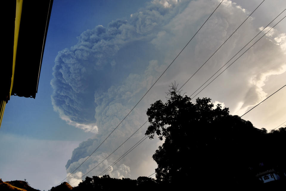 Ash rises into the air as La Soufriere volcano erupts on the eastern Caribbean island of St. Vincent, Tuesday, April 13, 2021. (AP Photo/Orvil Samuel)