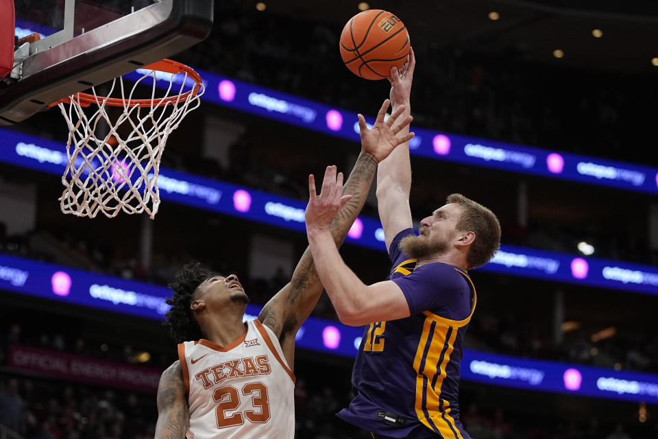 LSU forward Hunter Dean, right, shoots over Texas forward Dillon Mitchell (23) during the second half of an NCAA college basketball game, Saturday, Dec. 16, 2023, in Houston. (AP Photo/Kevin M. Cox)