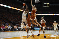 Tennessee forward Julian Phillips (2) shoots over Texas guard Arterio Morris (2) and forward Dylan Disu (1) during the first half of an NCAA college basketball game Saturday, Jan. 28, 2023, in Knoxville, Tenn. (AP Photo/Wade Payne)