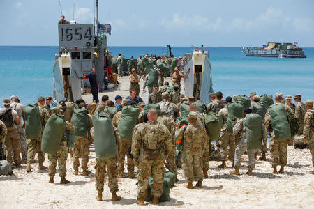 Soldiers from the 602nd Area Support Medical Company and other Army personnel board a Navy landing craft during their evacuation in advance of Hurricane Maria, in Charlotte Amalie, St. Thomas, U.S. Virgin Islands September 17, 2017. REUTERS/Jonathan Drake