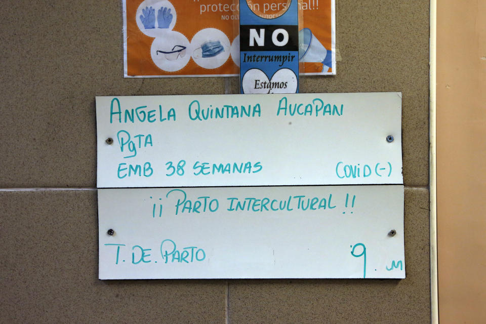 A sign that reads in Spanish “Angela Quintana Aucapan. 38 weeks pregnant. Covid negative. Intercultural birth.” is posted on the door of Angela Quintana Aucapan´s room as she settles in to give birth at the San Jose de Osorno Base Hospital in Osorno, Chile, Friday, Aug. 19, 2022. About 20 of the hospital’s 1,500 births each year are intercultural deliveries. (AP Photo/Luis Hidalgo)