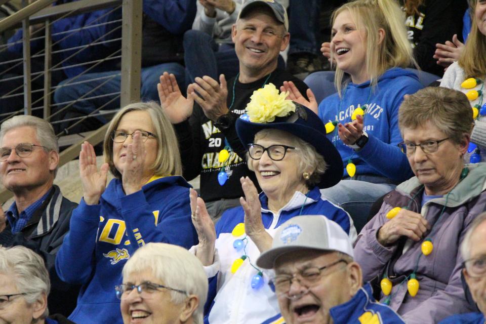 Former SDSU president Peggy Miller (center) cheers at the national championship celebration on Tuesday night at the SJAC