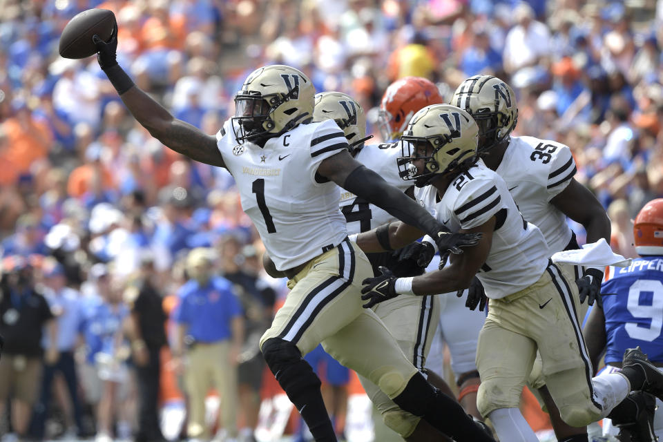 Vanderbilt linebacker Elijah McAllister (1) celebrates after intercepting a pass intended for Florida tight end Keon Zipperer (9) during the first half of an NCAA college football game, Saturday, Oct. 9, 2021, in Gainesville, Fla. (AP Photo/Phelan M. Ebenhack)