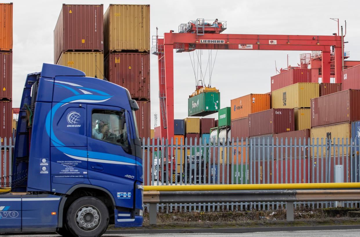 Shipping containers are pictured as a freight lorry or heavy goods vehicle (HGV) leaves from Dublin Port in Dublin, Ireland on January 12, 2021. - Northern Ireland's supply chain is "within days of falling apart" as new post-Brexit checks stem the flow of freight into the UK province, hauliers warned on Monday. Supermarkets are "experiencing considerable difficulties" stocking shelves since the Brexit transition period ended, said Road Haulage Association (RHA) policy manager for Northern Ireland John Martin. (Photo by PAUL FAITH / AFP) (Photo by PAUL FAITH/AFP via Getty Images)