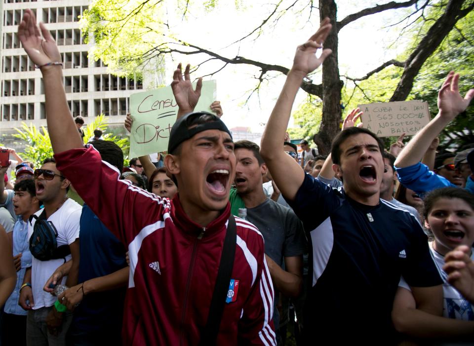 Students shout slogans against Venezuela's President Nicolas Maduro during a march to Venezuelan Telecommunications Regulator Office or CONATEL in Caracas, Venezuela, Monday, Feb17, 2014. The students, who’ve spent the past week on the streets alternating between peaceful protests by day and battles with police at night, marched on Monday to Venezuela’s telecom regulator to demand it lift all restrictions on the media’s coverage of the unfolding political crisis. (AP Photo/Alejandro Cegarra)