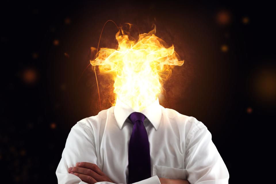 Business man with burnout syndrome and burning head. Source: Getty