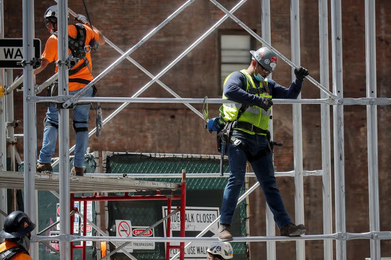 Construction workers assemble a scaffold at a job site, as phase one of reopening after lockdown begins, during the outbreak of the coronavirus disease (COVID-19) in New York