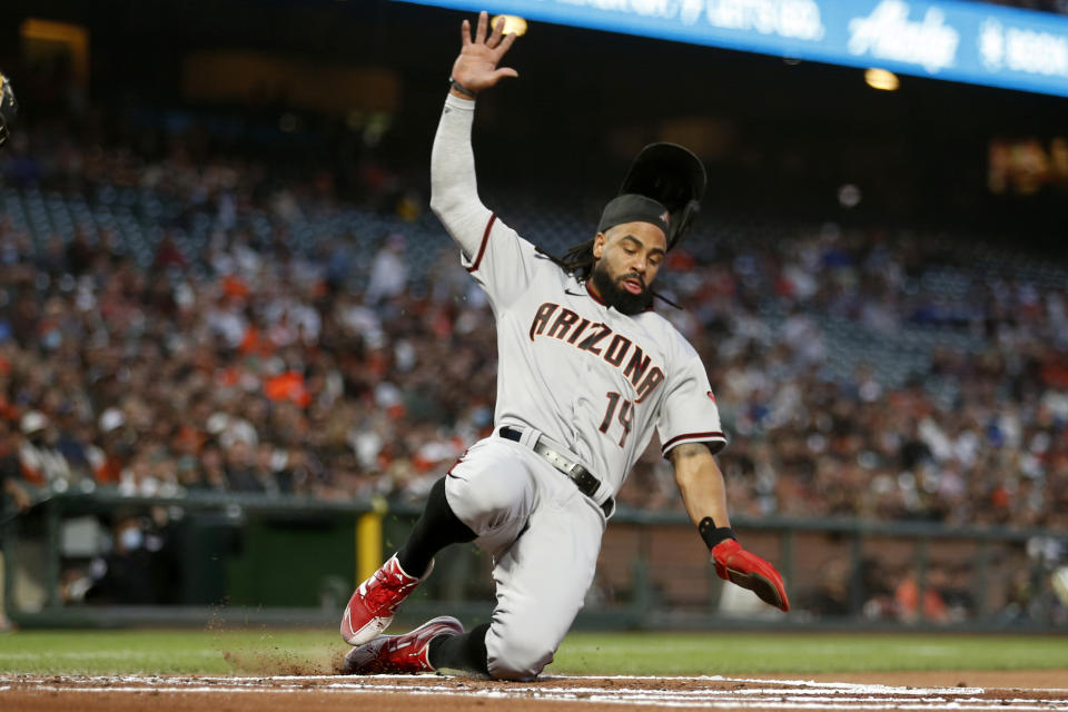Arizona Diamondbacks' Henry Ramos slides home on a single hit by Carson Kelly against the San Francisco Giants during the first inning of a baseball game in San Francisco, Thursday, Sept. 30, 2021. (AP Photo/Jed Jacobsohn)