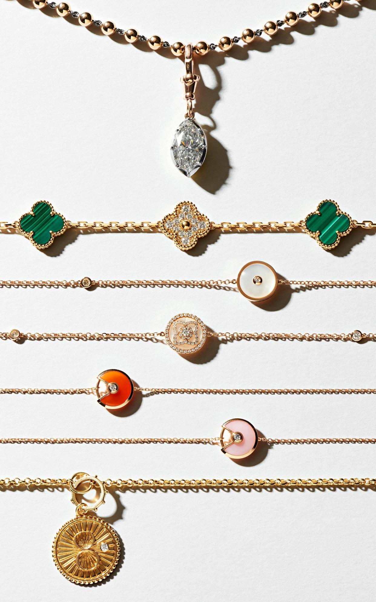 From top: 18ct-yellow-gold, 18ct-white-gold, platinum and diamond Ball and Chain necklace, price on request, Jessica McCormack; Yellow-gold, malachite and diamond Vintage Alhambra necklace, £51,800, Van Cleef & Arpels; 18ct-rose gold, mother-of-pearl and diamond Enchanted Lotus sautoir, £15,900, De Beers; 18ct-pink-gold, pink-opal, carnelian, chrysoprase and diamond Amulette de Cartier necklace, £9,000, Cartier; 18ct-gold 36in chain, £1,630, and 18ct-gold and diamond Karma Mama charm, £1,785, Foundrae at Browns - PHILIPPE FRAGNIERE