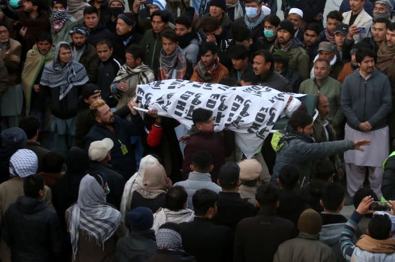 People and family members carry a body of their relative, who was a coal miner and got killed along with other coworkers from Pakistan's minority Shi'ite Hazara community by unidentifyed persons in Mach area of Bolan district, in Quetta