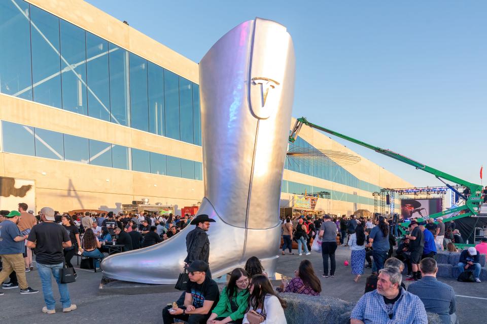 A giant cowboy boot is on display outside the Tesla Giga Texas manufacturing facility during the 