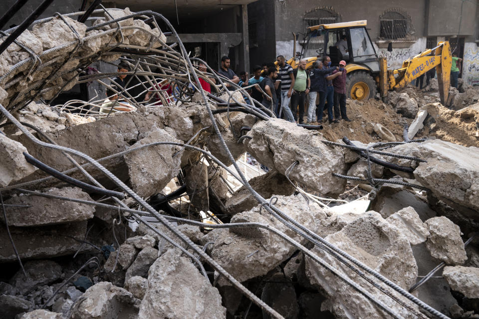 Twisted concrete, rebar, and wires lie beside a crater where the home of Ramez al-Masri was destroyed by an air-strike prior to a cease-fire reached after an 11-day war between Gaza's Hamas rulers and Israel, Sunday, May 23, 2021, in Beit Hanoun, the northern Gaza Strip. (AP Photo/John Minchillo)