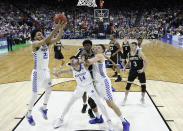 <p>Kentucky’s EJ Montgomery, left, grabs a Wofford rebound as Tyler Herro (14) holds back Wofford players during the first half of a second-round game in the NCAA men’s college basketball tournament in Jacksonville, Fla., Saturday, March 23, 2019. (AP Photo/Stephen B. Morton) </p>