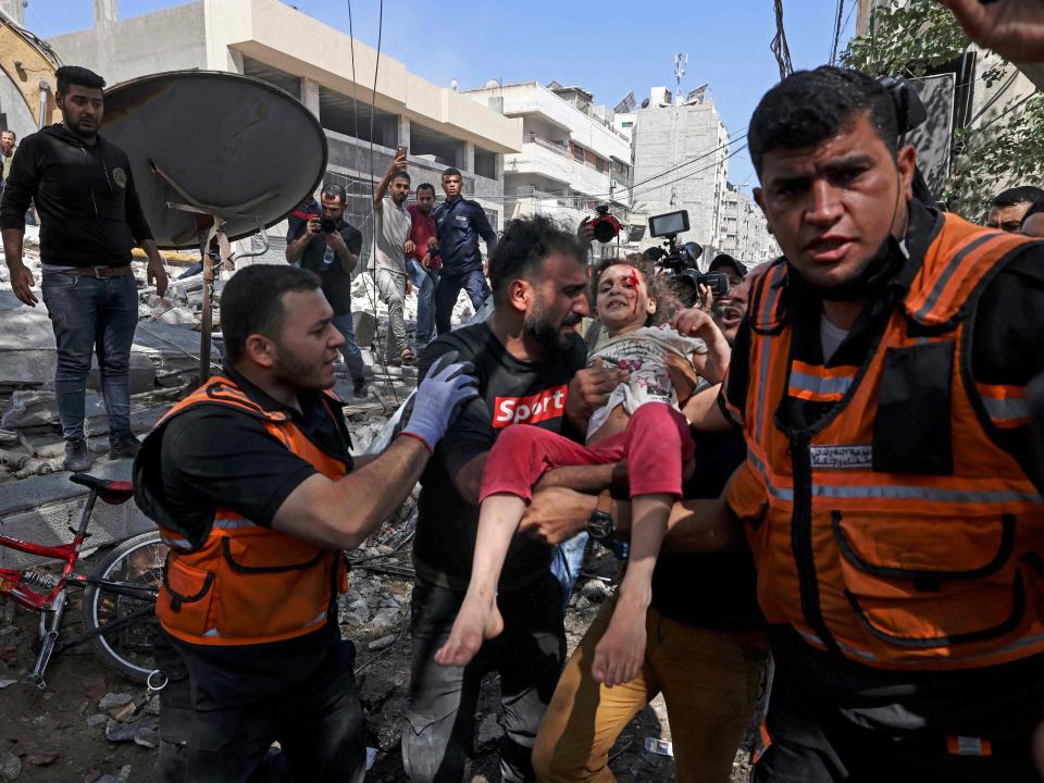 Paramedics evacuate a child in Gaza CityAFP via Getty Images