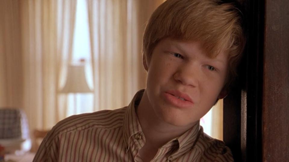 Jesse Plemons leans against the wall