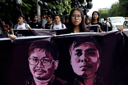 People march to show solidarity for jailed Reuters journalists Wa Lone and Kyaw Soe Oo two days before a local court is due to deliver verdict against them on charges of breaching the country's Official Secrets Act in Yangon, Myanmar, September 1, 2018. REUTERS/Ann Wang