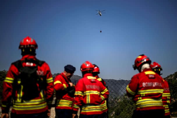 PHOTO: A firefighting helicopter flies over as firefighters prepare to tackle a wildfire in Murca, Portugal, July 20, 2022. (Patricia De Melo Moreira/AFP via Getty Images)