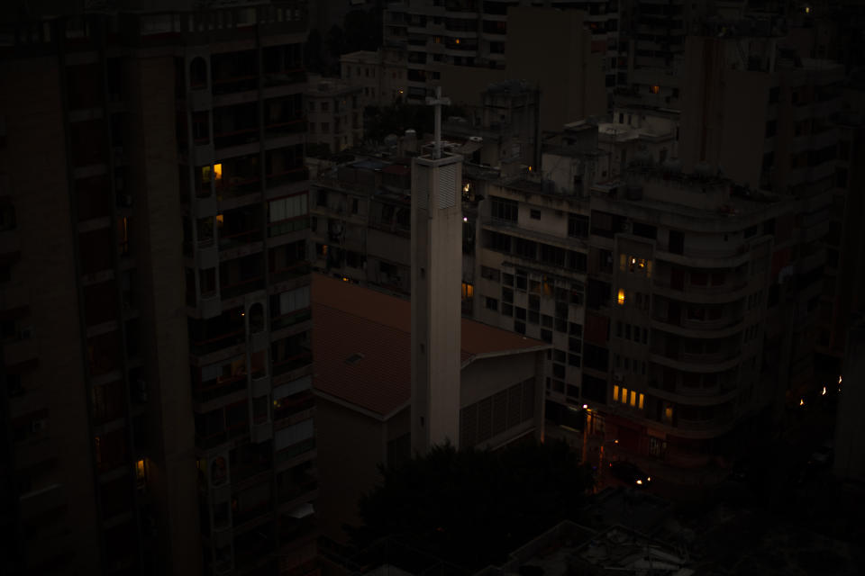 The capital city of Beirut remains in darkness during a power outage, Monday, July 6, 2020. The government in highly indebted Lebanon is in talks with the International Monetary Fund to secure financial assistance. But the talks have been bogged down by political divisions. Poverty and unemployment have been rising, only to be compounded by the economic restrictions imposed in effort to try to curb the spread of the coronavirus. (AP Photo/Hassan Ammar)